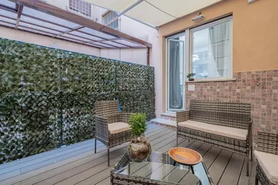 a patio with benches and a green wall at Carlo's House Suite with Private Terrace in Rome