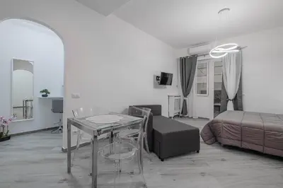a living room with a glass table and a bed at Carlo's House Suite with Private Terrace in Rome