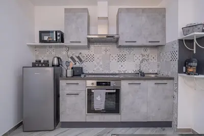 a kitchen with stainless steel appliances and a refrigerator at Carlo's House Suite with Private Terrace in Rome
