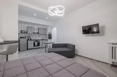 a living room with a bed and a kitchen at Carlo's House Suite with Private Terrace in Rome