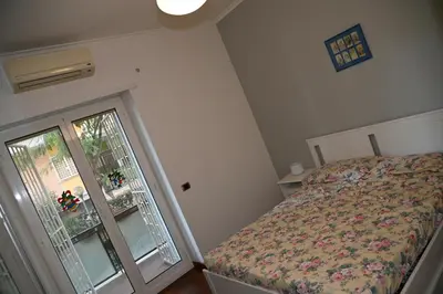 a small bedroom with a bed and a window at Casa 12 in Rome