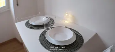 a table with two plates and glasses on it at Appartamento Cornelia near San Pietro in Rome