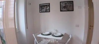 a small white table with plates and bowls on it at Appartamento Cornelia near San Pietro in Rome