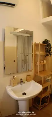 a bathroom with a white sink and a mirror at Appartamento Cornelia near San Pietro in Rome