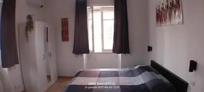 a bedroom with a bed in a room with a window at Appartamento Cornelia near San Pietro in Rome