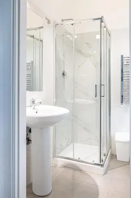 a white bathroom with a shower and a sink at Roman Waves Room - 2 MIN Metro Marconi - 15 MIN Colosseo - A-C & WIFI in Rome