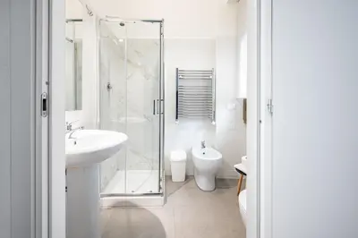 a bathroom with a shower and a sink and a toilet at Roman Waves Room - 2 MIN Metro Marconi - 15 MIN Colosseo - A-C & WIFI in Rome