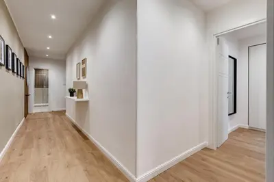 an empty hallway with white walls and wood floors at Scipioni Luxury Apartment in Rome