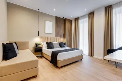 a bedroom with a bed and a couch at Scipioni Luxury Apartment in Rome