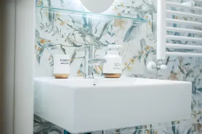 a bathroom with two bottles of soap on a sink at 10 Min from Termini Sisters Cozy Rome Apartment in Rome