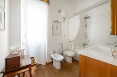 a bathroom with a sink and a toilet and a tub at La Dimora dell'Antiquario in Rome