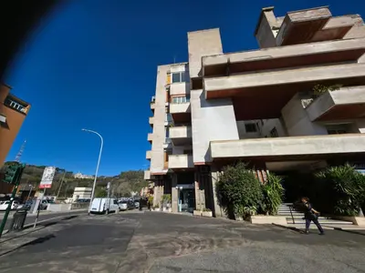 a person walking down a street next to a building at La Dimora dell'Antiquario in Rome