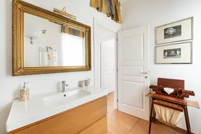 a bathroom with a sink and a mirror at La Dimora dell'Antiquario in Rome