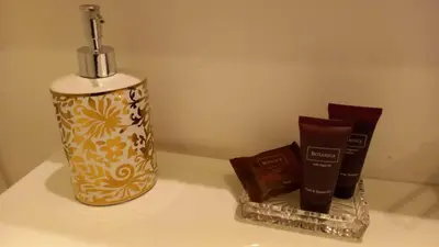 a bottle of soap and a container of chocolate at La Dimora dell'Antiquario in Rome