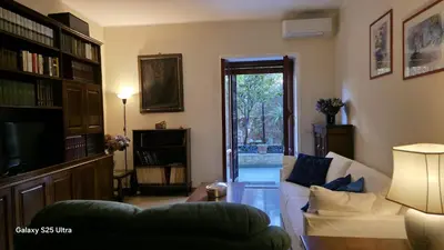 a living room with a couch and a tv at Casa Orietta in Rome