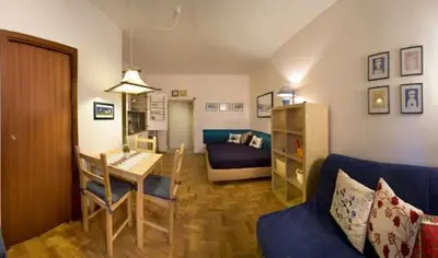 a living room with a blue couch and a table at Casa Orietta in Rome