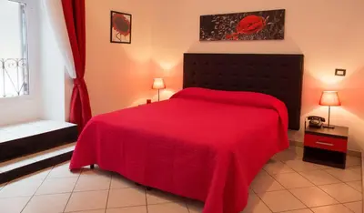 a bedroom with a red bed with a red blanket at B&B Trastevere in Bed in Rome