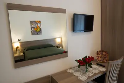 a bedroom with a mirror and a bed and a table at B&B Trastevere in Bed in Rome