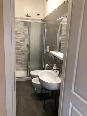 a bathroom with two sinks and a shower at B&B Trastevere in Bed in Rome