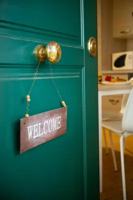 a welcome sign hanging on a green cabinet at Appartamento Rea Silvia in Rome