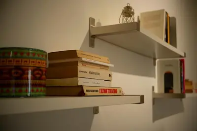 a stack of books on a shelf in a room at Appartamento Rea Silvia in Rome