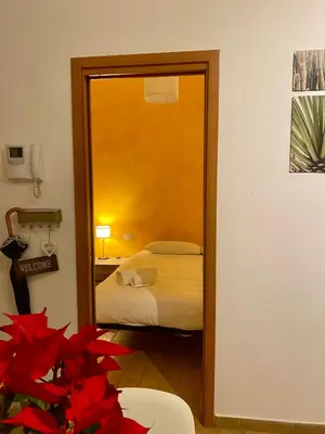 a bedroom with a mirror and a bed in a room at Appartamento Rea Silvia in Rome