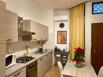 a kitchen with a table and a stove top oven at Appartamento Rea Silvia in Rome