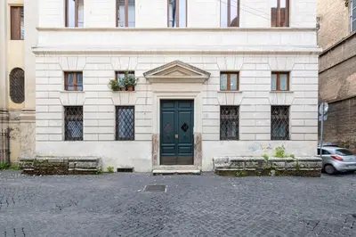 a building with a green door on a street at Casa Giulia, a Burghesius home in Rome