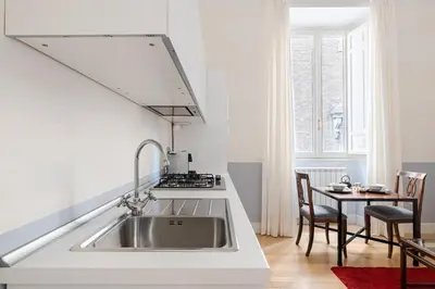 a kitchen with a sink and a table at Casa Giulia, a Burghesius home in Rome