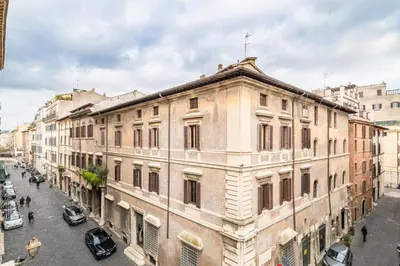 an old building on a city street with cars at Casa Giulia, a Burghesius home in Rome