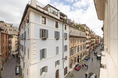 a white building on a street in a city at Casa Giulia, a Burghesius home in Rome