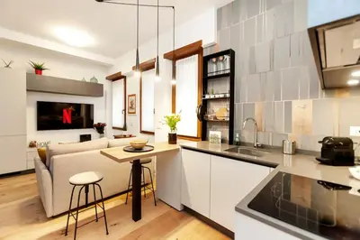 a kitchen and living room with a couch and a table at Dimora Cavallini in Rome