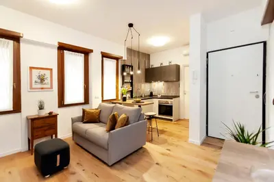 a living room with a couch and a kitchen at Dimora Cavallini in Rome