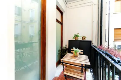 a balcony with a wooden bench and a table at Dimora Cavallini in Rome