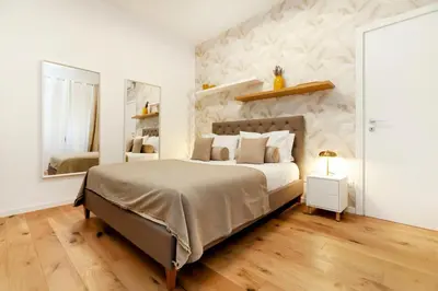 a bedroom with a large bed and a mirror at Dimora Cavallini in Rome