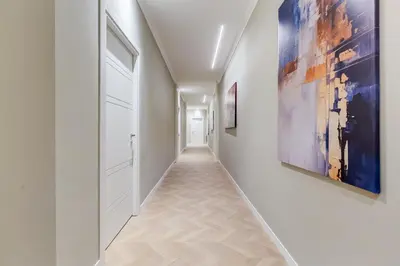 a hallway with white walls and paintings on the walls at Dionigi 43 Private Suites by Premium Suites Collection in Rome