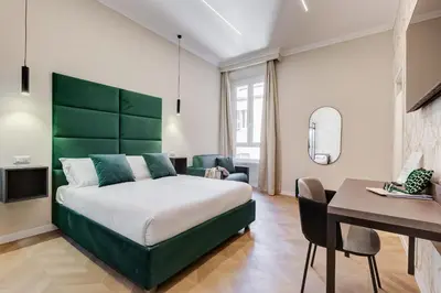 a bedroom with a large bed and a desk at Dionigi 43 Private Suites by Premium Suites Collection in Rome