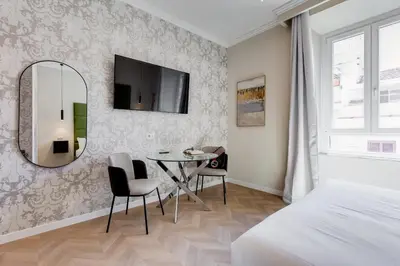a bedroom with a table and a mirror and a bed at Dionigi 43 Private Suites by Premium Suites Collection in Rome