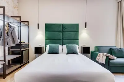 a bedroom with a large white bed and a couch at Dionigi 43 Private Suites by Premium Suites Collection in Rome