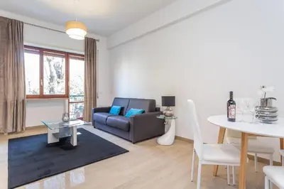 a living room with a couch and a table at St Peter apartment with Garage in Rome
