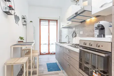 a kitchen with a sink and a stove top oven at St Peter apartment with Garage in Rome