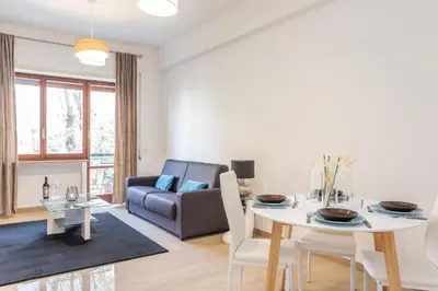 a living room with a table and a couch at St Peter apartment with Garage in Rome