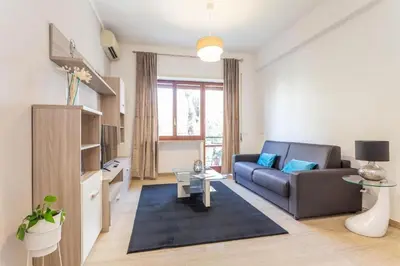 a living room with a couch and a table at St Peter apartment with Garage in Rome