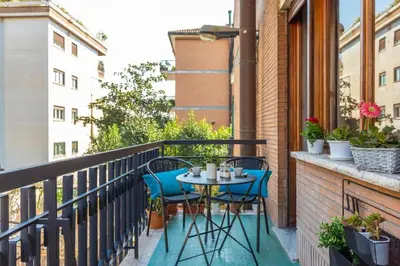 a balcony with a table and chairs on it at St Peter apartment with Garage in Rome