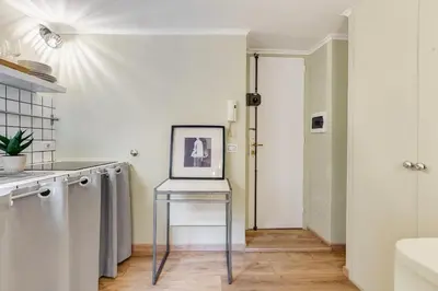a kitchen with a table with a laptop on it at La Casina your suite in Monti in Rome