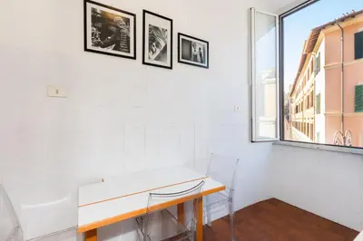 a white room with a desk and a window at Casa Assunta in Rome
