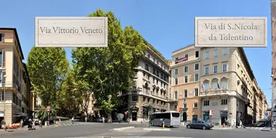 a street with two street signs in a city at Vittoria Charme in Rome