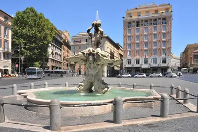 a statue in the middle of a city street at Vittoria Charme in Rome