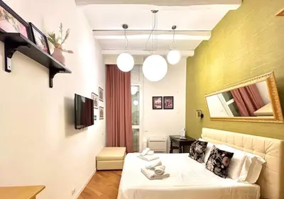 a hotel room with a bed and a tv at Vittoria Charme in Rome