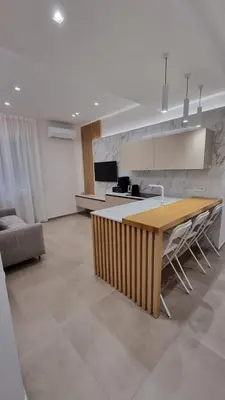 a kitchen with a wooden table in a living room at T&T Luxury Home Rome Int 5 in Rome
